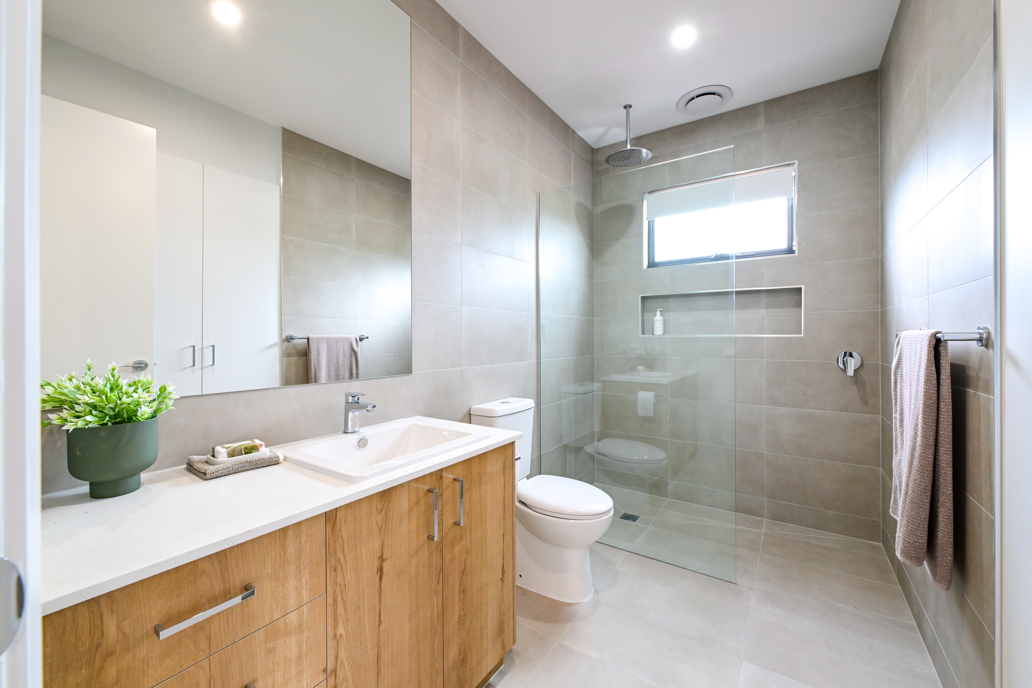 modern classic bathroom with floor to ceiling tiles